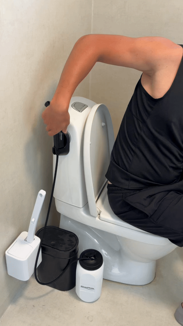 RinseMate wand in use — a steady stream of water for a proper clean.