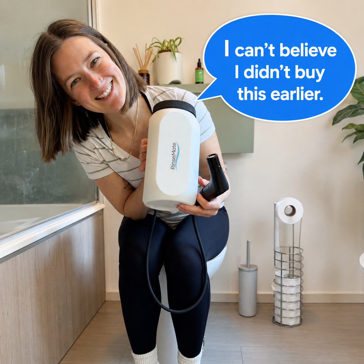 Happy RinseMate customer holding the tank and wand in a bathroom, with a speech bubble: I can't believe I didn't buy this earlier.